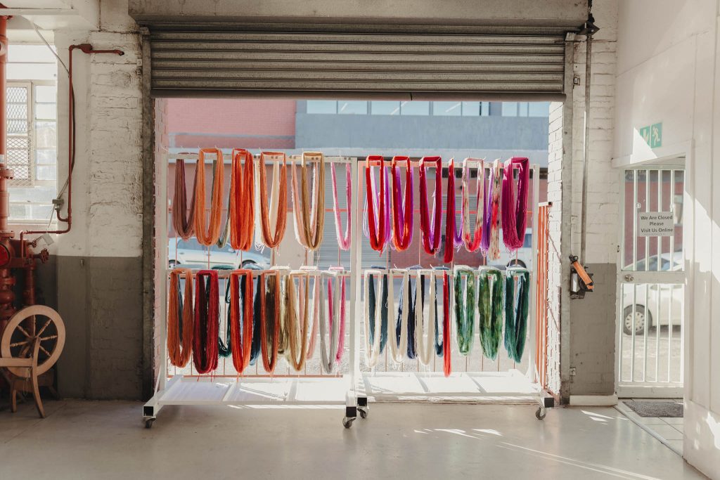 Colourful skeins of hand dyed yarn hang to dry in the sun at the Cowgirlblues studio.