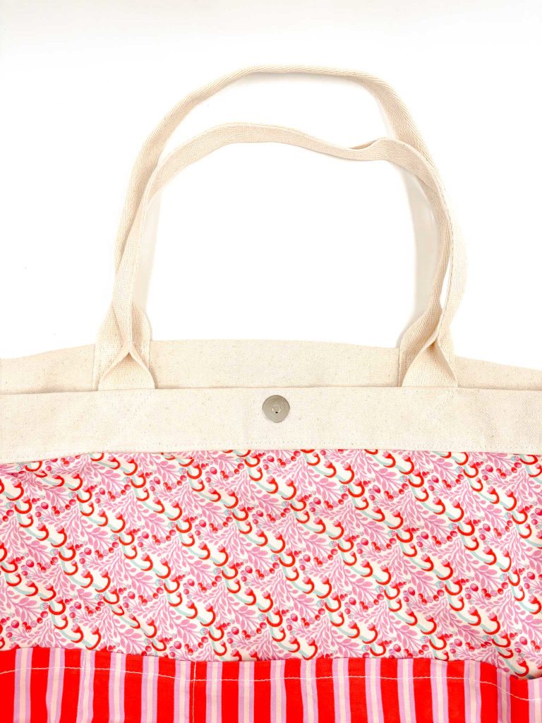 A tote bag for storing knitting projects has a vibrant coloured lining, made using textile offcuts from local brands.